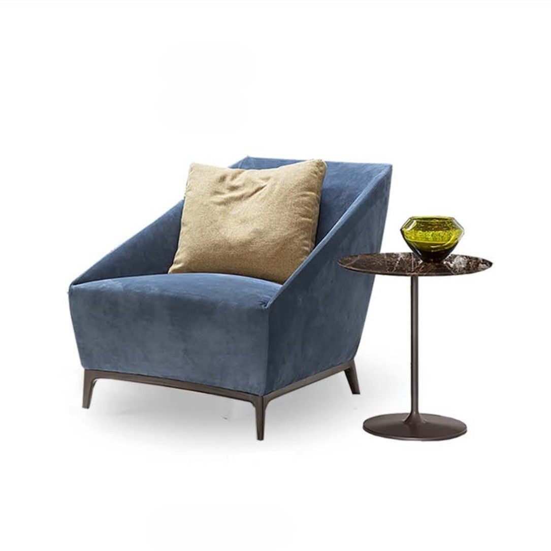 Zoe Armchair by Alivar, featuring a sculptural silhouette and slim cast aluminum legs, complemented by a modern side table.