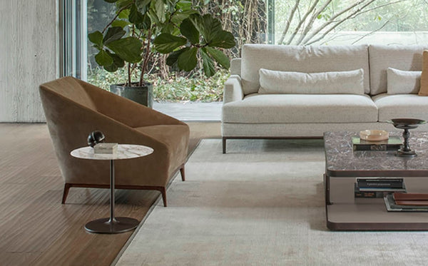 Zoe Armchair by Alivar in brown leather, paired with a minimalist side table, highlighting its clean lines and contemporary style.