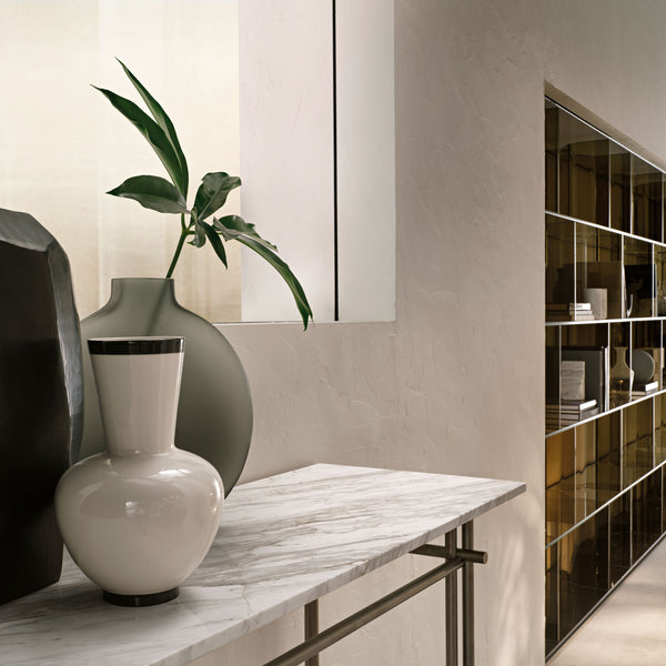 FIAM Cristaline console with a 15mm  marble top and a matte titanium metal base, blending luxury and simplicity for elegant interiors.