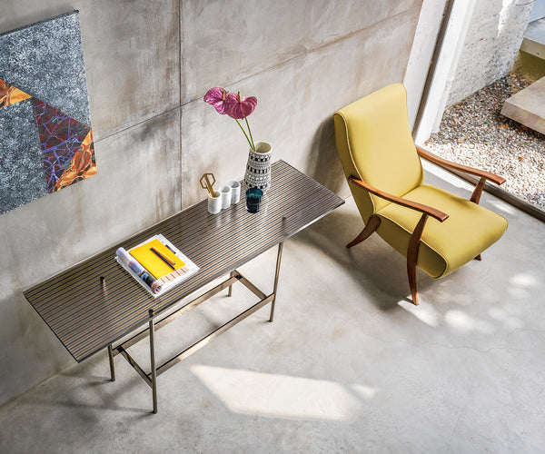 Waves Console by FIAM Italia with a bronze DV-GLASS® top and sculptural metal base, illustrating its modern Italian elegance.