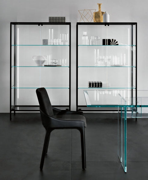 Modern glass display cabinets with black frames and a black chair