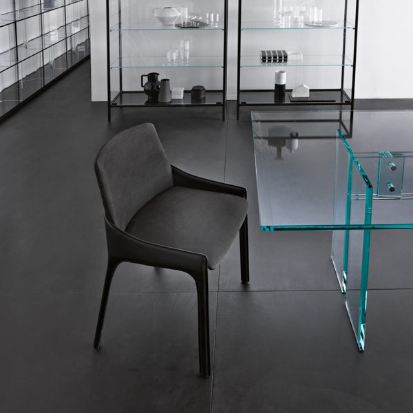 Modern glass display cabinets with black frames and a black FIAM Plie chair