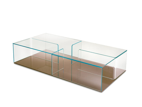 Side view of Quadra coffee table showcasing intersecting curved glass elements and minimalist design.