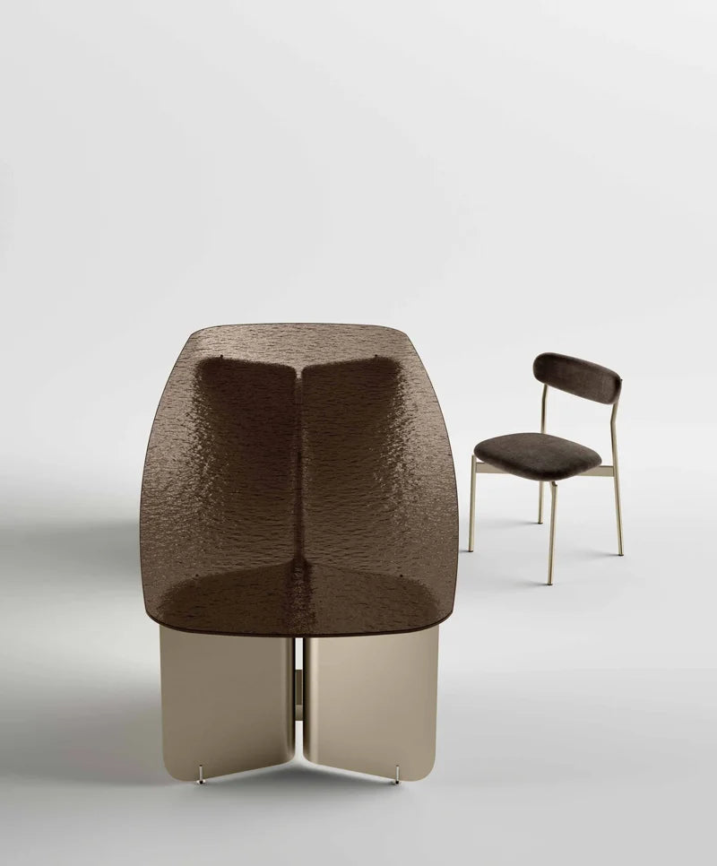 Pleat dining table with fused bronze glass top and champagne base