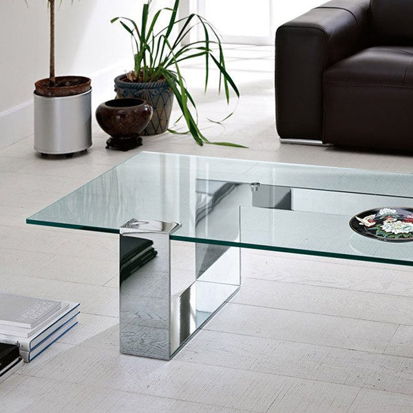 Plinsky Coffee Table styled in a minimalist living room with a sofa,and decor on the glass surface.